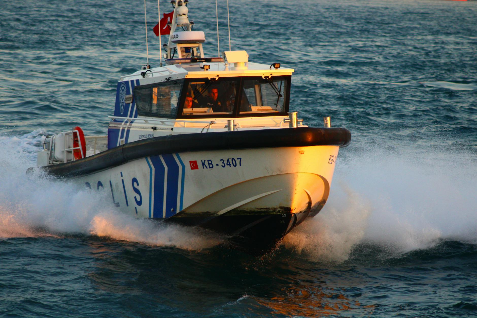 Yacht bow cutting through Mediterranean waves at speed