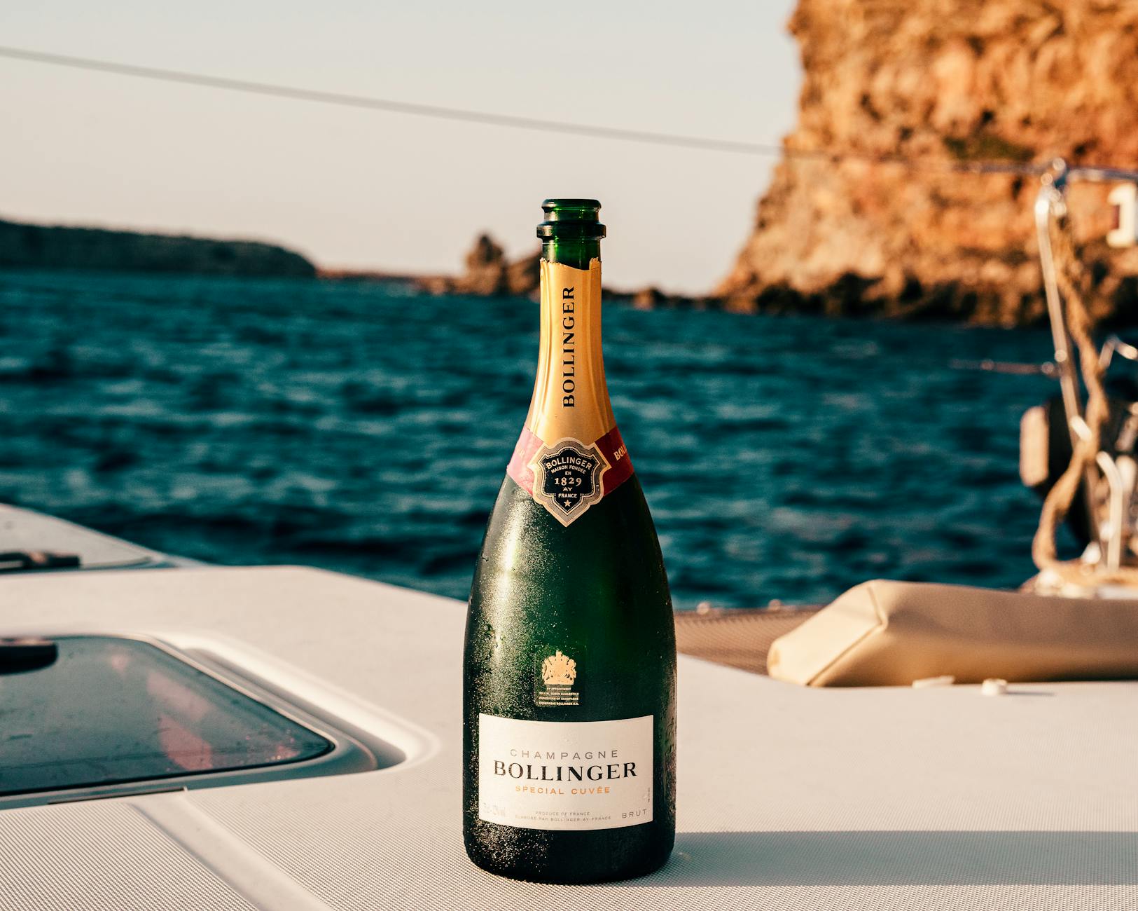 Champagne toast on the deck of a yacht at sunset