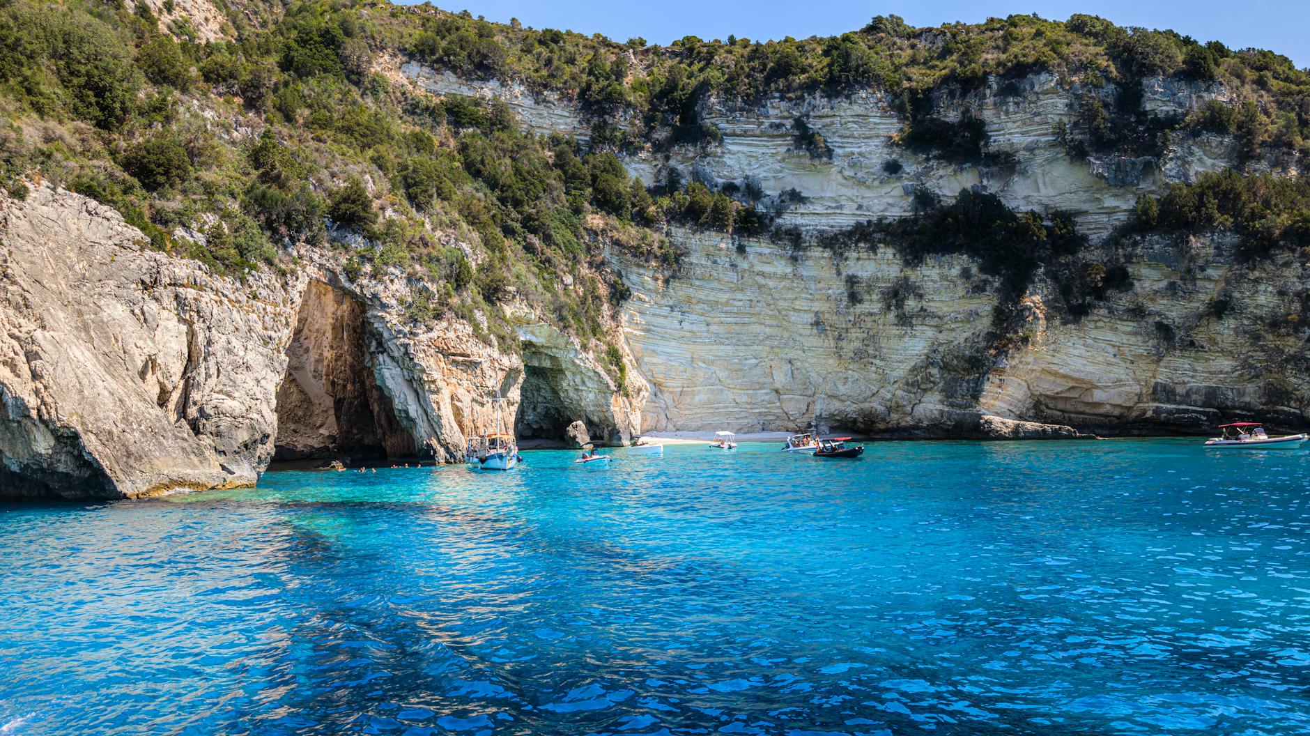 Private boat tour entering a dramatic sea cave on the Mallorca coast